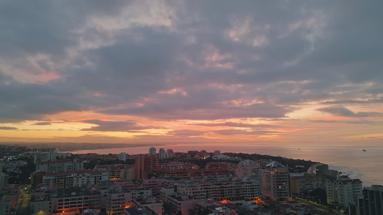 Scenic coastal town sunset aerial view. Mesmerising city ocean coast illuminated