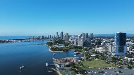 construction of a new adventure park created on the foreshore with a city skyline backdrop high drone view