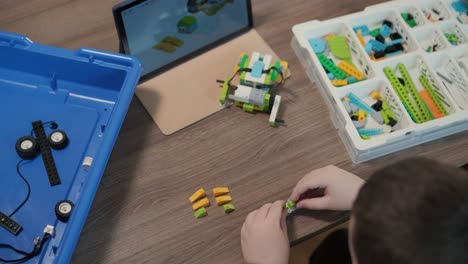 children engage in stem learning activities, assembling robotics kits with focus and teamwork in a classroom setting