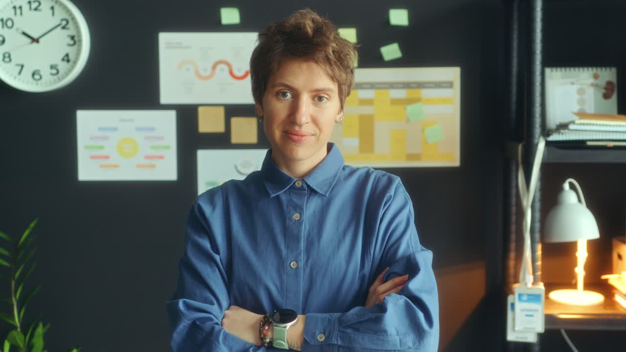 Portrait of Young Smiling Businesswoman Posing at Camera in Office