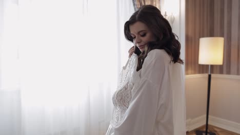 bride getting ready for her wedding day in a beautiful white gown