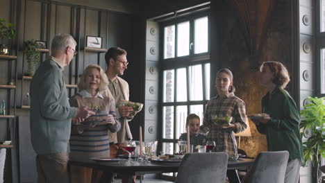 happy family preparing table to have meal together