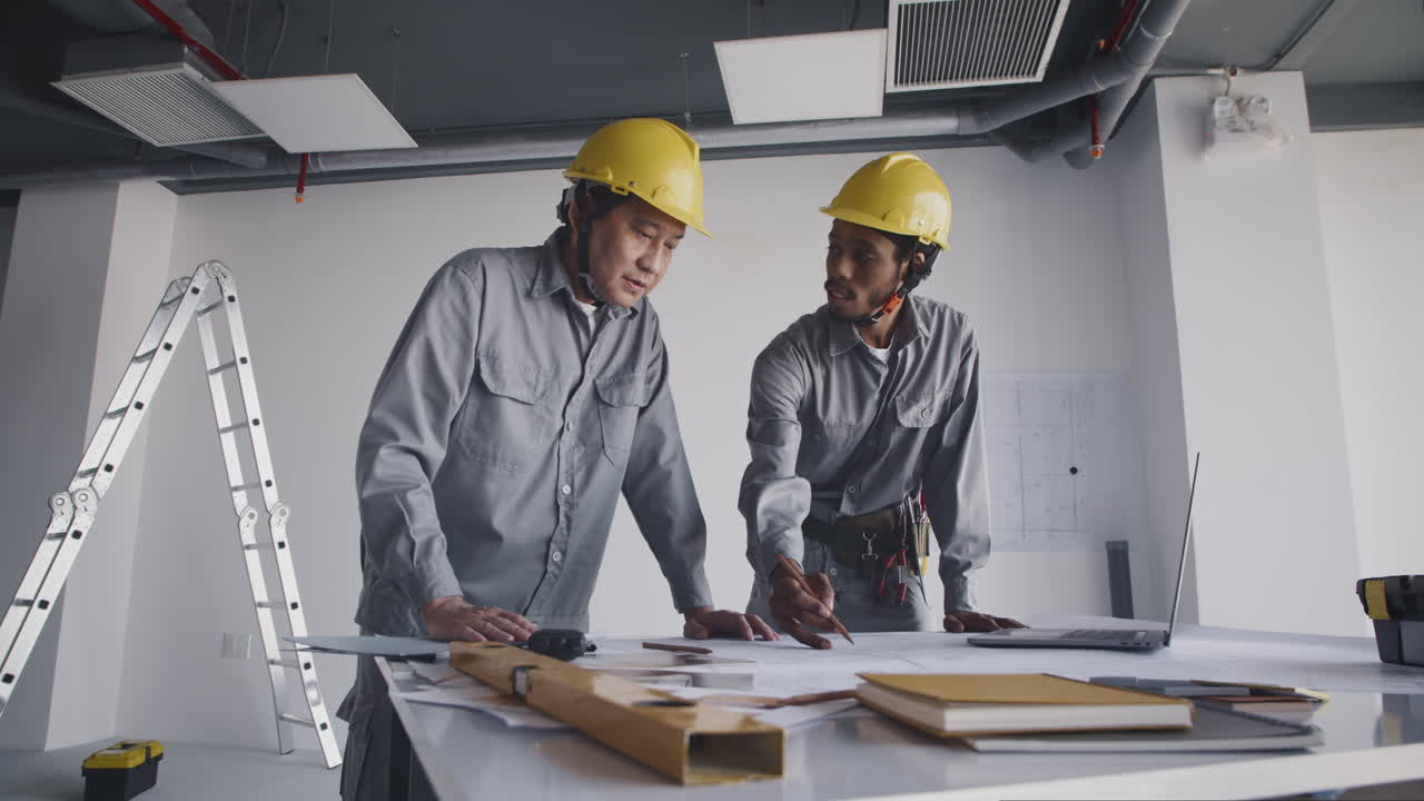 Diverse Builders Working on Room Blueprint