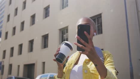 Mixed-race-woman-drinking-coffee-on-the-street