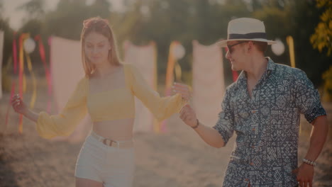 happy young couple dancing at beach