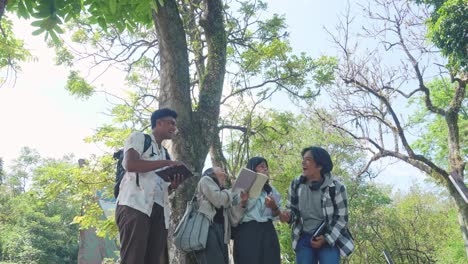 happy young interracial college students chatting and laughing with each other after class standing outside