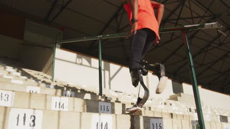 disabled mixed race man with prosthetic legs running on stairs