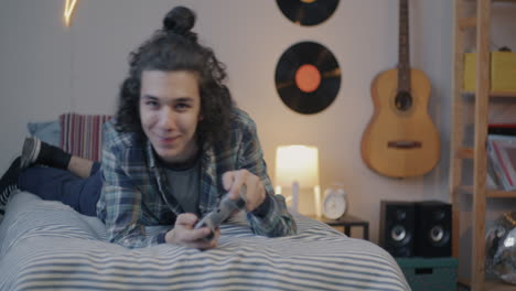 teenager playing video games in bedroom