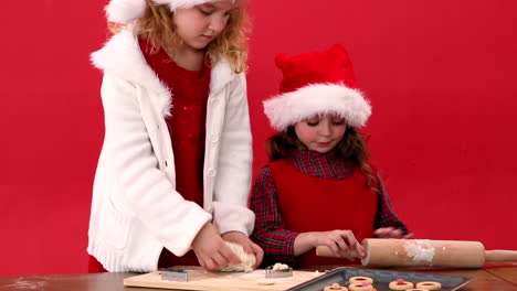 Cute-festive-sisters-making-christmas-cookies