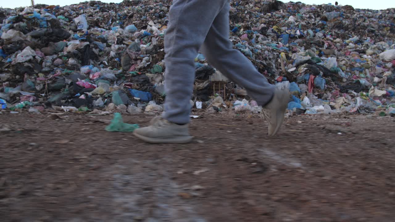 Person walking through a landfill