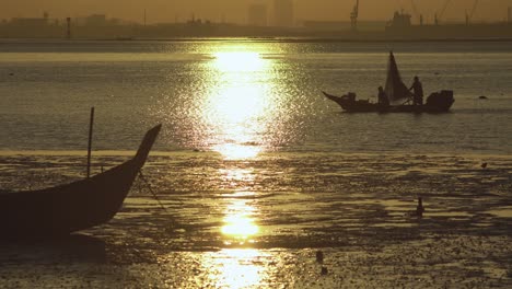 silhouette asian fisherman row boat