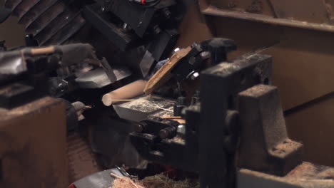 sliding shot of an automated wood carving and cutting machine operating in a manufacturing plant