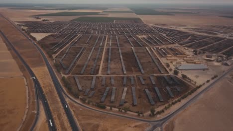 aerial wide pull back of huge cattle farm, feedlot