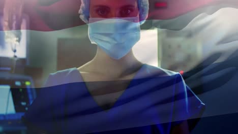 animation of flag of netherlands waving over anesthesiologist in operating theatre