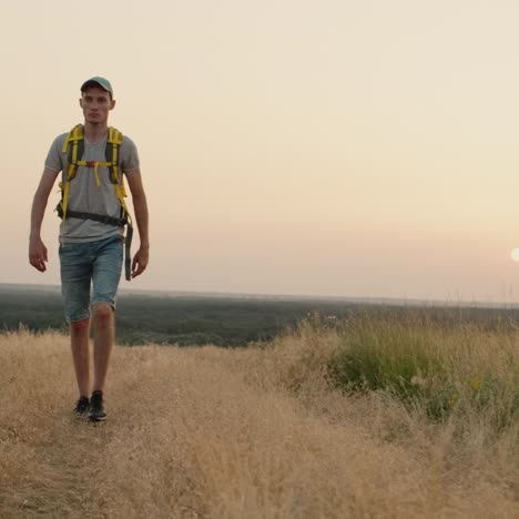 Person-Walking-On-A-Field-Road