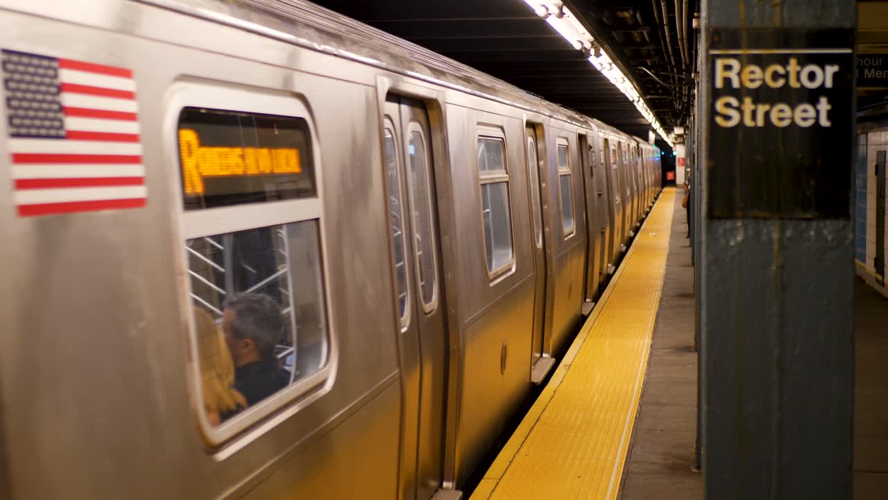Slow motion landscape of subway cart train carriage windows at Rector Street station underground platform New York City Manhattan USA America transport metro travel urban