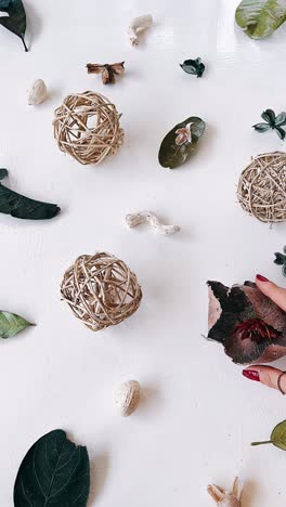 hand arranging decorative items on white background