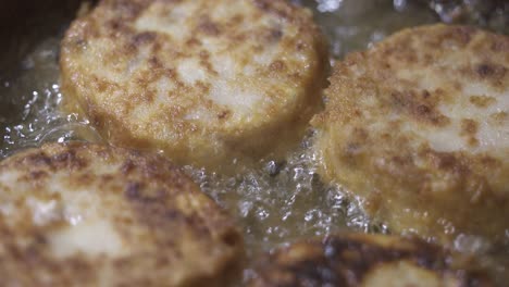 сooking homemade fried fish burger patty. frying fish patties with hot oil