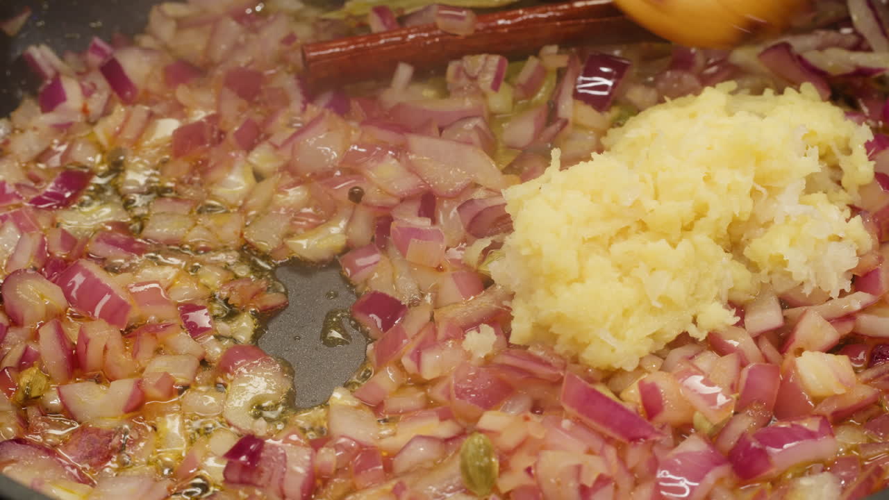 Cooking red onion and garlic in a pan