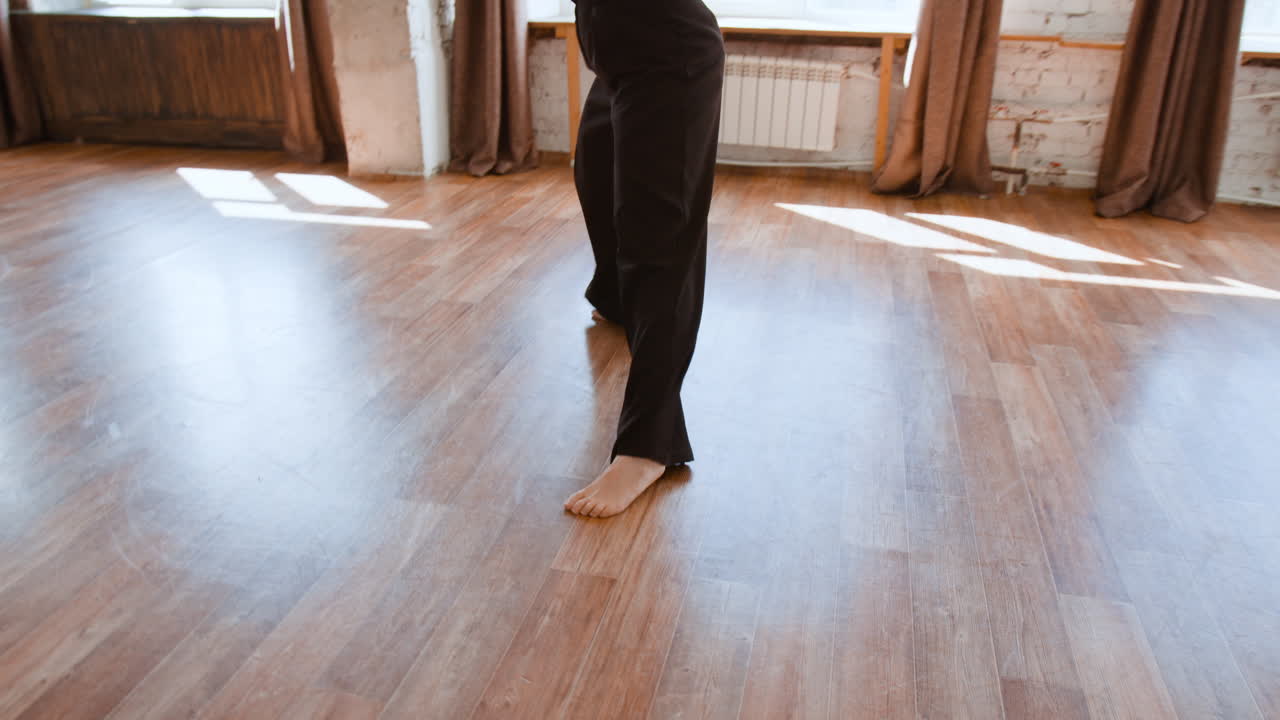Person Dancing or Practicing in a Bright Studio