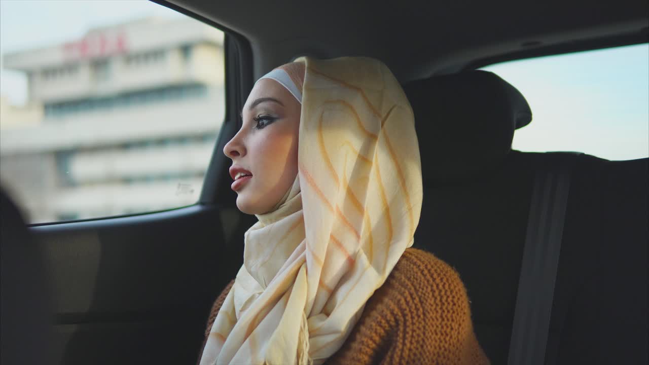 Woman in Hijab Traveling in a Car