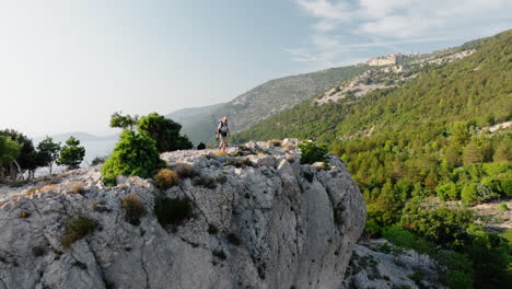 hiker walks up to stunning overlook of lubenice croatia standing strong to take in scenic mountain views