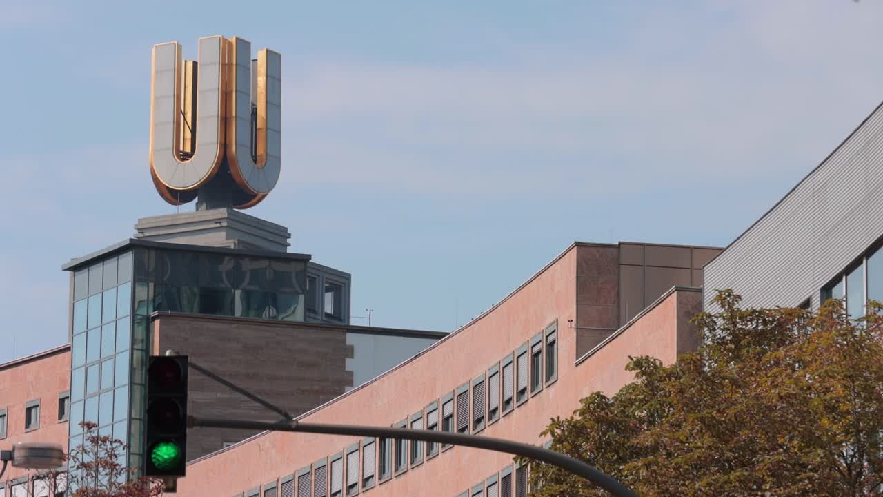 Green light for the Dortmunder U tower against a blue sky, close up shot