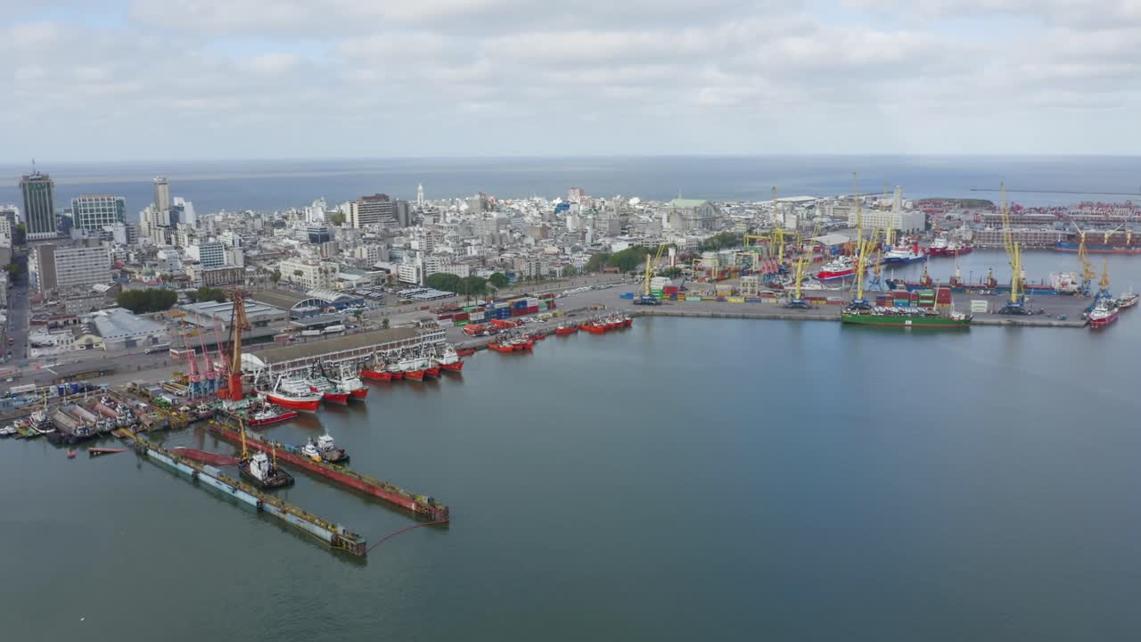 Uruguay capital city Montevideo. Forward moving aerial drone view of barrio Ciudad Vieja, seen from above the port. Calm cloudy weather