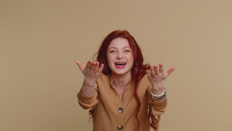 redhead woman appear from below waving hi with her palm, greeting with hospitable friendly smile