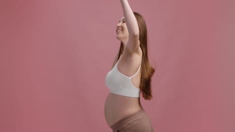 happy pregnant woman dancing