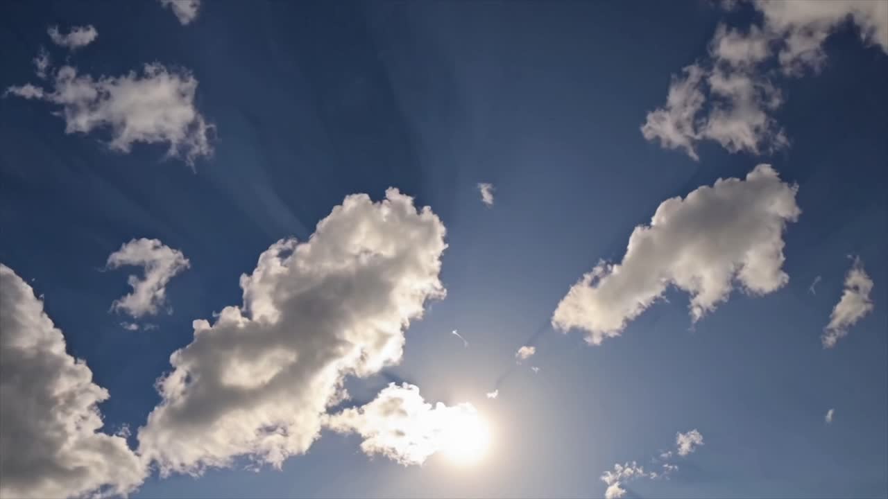 CGI 4K timelapse of a clear blue sky with moving clouds, creating a relaxing and serene nature scene that evokes calmness and tranquility.