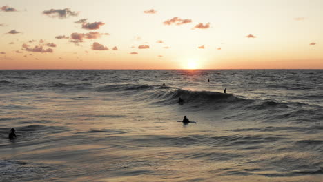 Surfers-in-front-of-the-touristic-town-Domburg-in-the-Netherlands-during-sunset