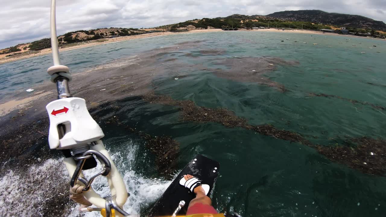 Dirty sea water polluted by trash, Son Hai beach, Vietnam, kitesurfing pov