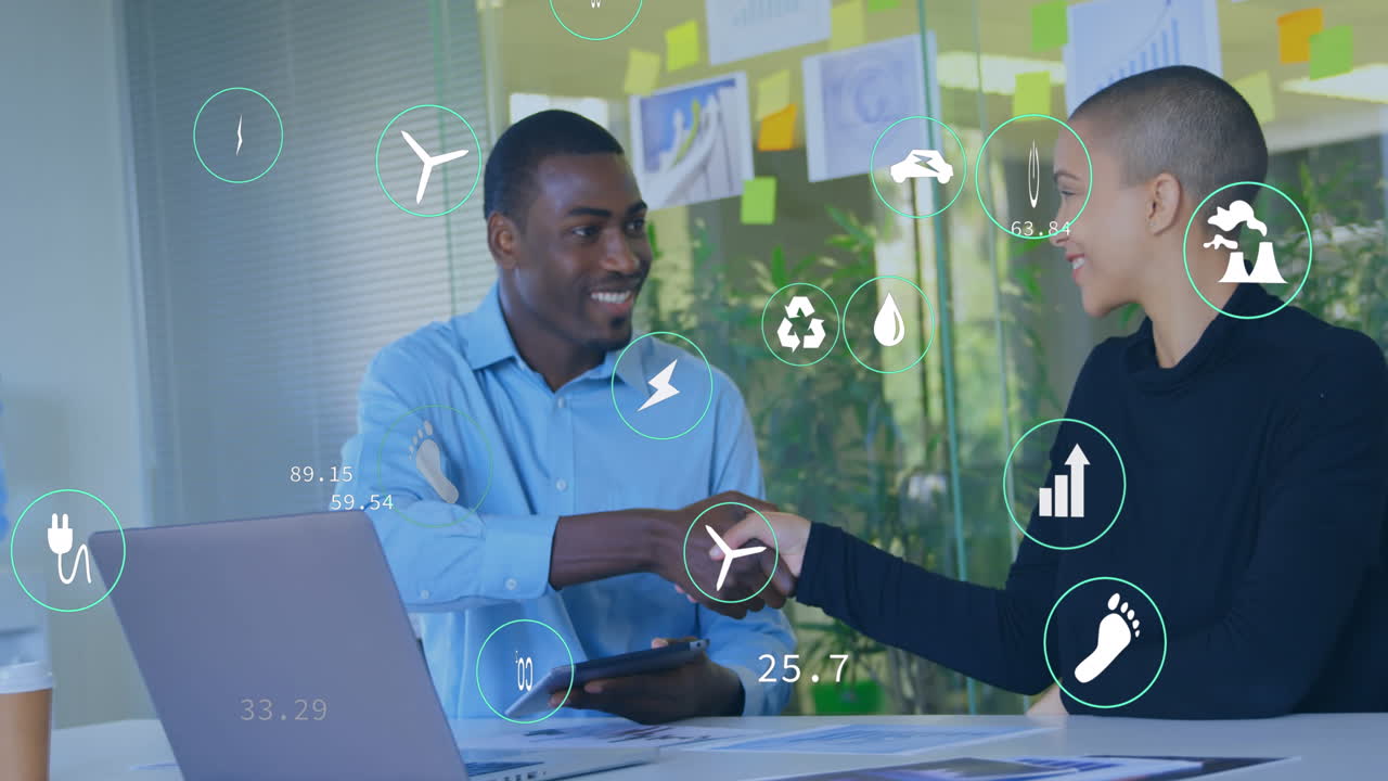 Animation of icon in circles over diverse coworkers shaking hands in office