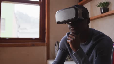 African-American-man-wearing-VR-headset-at-home