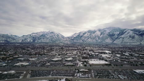 Pan-up-cars-highway-SLC-Wasatch-Range-Utah-mid-winter-cold-snowy-fog-cloudy-high-city-scape-March-2019
