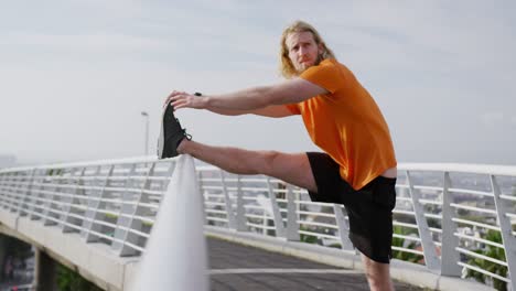 sporty caucasian man training on a bridge