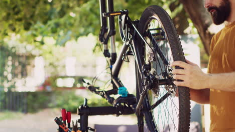 caucasian man repairing modern bicycle