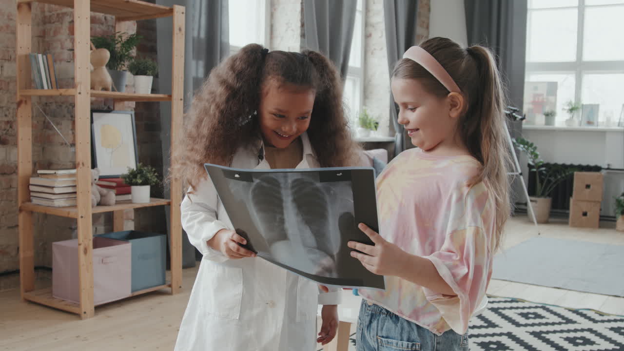 Cute Little Girls Looking at X-Ray Scan