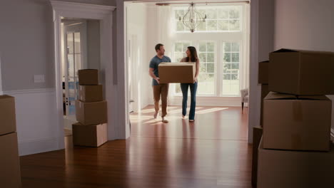 couple moving boxes into a new home
