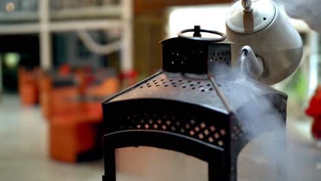 Closeup-of-liquid-nitrogen-being-poured-on-lantern-at-bar,-shallow-DOF