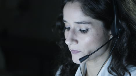 businesswoman in headset talking in dark office