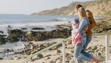 Side-view-of-caucasian-family-walking-at-beach-on-a-sunny-day-4k