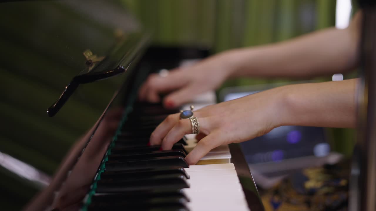 Close-up of hands playing a piano