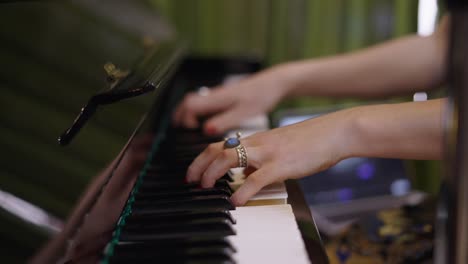 close-up of hands playing a piano