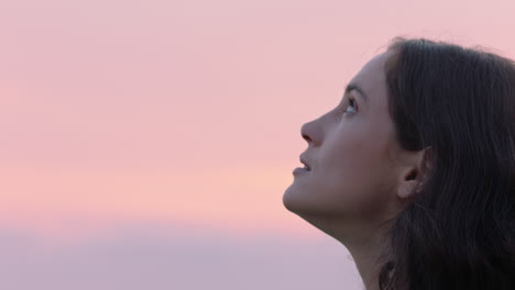 close up portrait of beautiful woman exploring spirituality looking up praying contemplating journey with wind blowing hair in countryside enjoying peaceful sunset