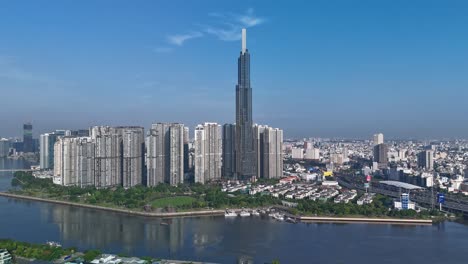 drone hyperlapse of landmark building on the saigon river with clear blue sky