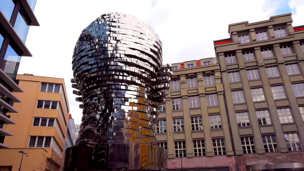 Prague, Czech Republic - November 2, 2021: Head of Franz Kafka stands in the vibrant center of Prague. This captivating artwork attracts visitors with its unique design and modern aesthetic against historical architecture