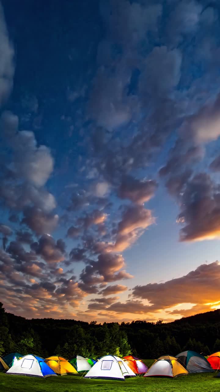 A vibrant video still of colorful tents under a dramatic sunset sky