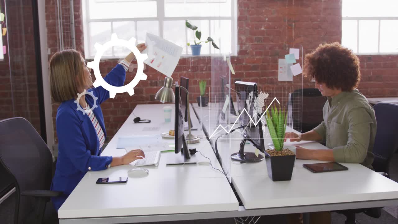 Pair collaborating, woman lifting report over screen and passing to man, causing analytics overlays